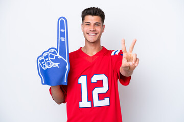 Young caucasian sports fan man isolated on white background smiling and showing victory sign