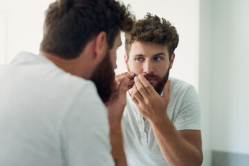 Sticker - Doing my early morning examination. Cropped shot of a handsome young man checking out his skin in the bathroom mirror.