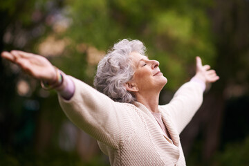 Wall Mural - Enjoying the peace and tranquility of her garden. Shot of a senior woman enjoying the outdoors.