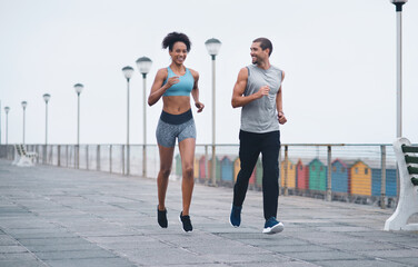 Sticker - Journeying on to great health and wellness together. Shot of two sporty young people exercising together outdoors.