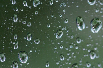 Wall Mural - Close-up on water drops on glass under the rain.