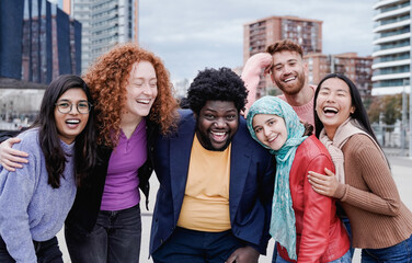 Multiracial happy friends having fun outdoor in city - Main focus on african curvy man