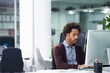 © Nicola K/peopleimages.com - Putting in the hours to get work done. Shot of a young businessman sitting at a desk.