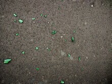Cracked Green Glass On The Cement Floor