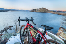 Lightweight Gravel Bike On A Rocky Cliff Overlooking A Mountain Lake - Winter Dusk Over Horsertooth Reservoir In Fort Collins, Colorado