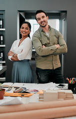 Poster - Together we build dreams. Cropped shot of two young architects working together in a modern office.