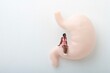 © marco - miniature figurine of a black woman sitting on a huge human stomach
