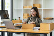 © PaeGAG - Starting Small business entrepreneur SME freelance,Portrait young woman working at home office, BOX,smartphone,laptop, online, marketing, packaging, delivery, SME, e-commerce concept