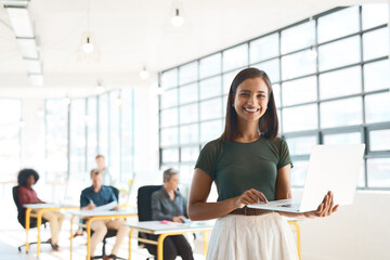 Aufkleber - Fresh ideas are what we thrive on. Portrait of a happy designer posing in the office while her colleagues work in the background.