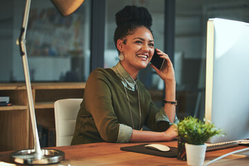 Poster - Just calling to let you know Ill be late. Shot of an attractive young woman using her cellphone in the office.