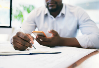 Canvas Print - Let me get that information off my phone. Shot of an unrecognizable businessperson using a cellphone in an office.