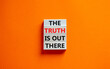 The truth is out there symbol. Concept words The truth is out there on wooden blocks. Beautiful orange table orange background. The truth is out there business concept. Copy space.