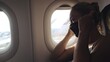© ivandanru - Woman travel caucasian at plane with wearing protective medical mask. Girl tourist at aircraft with protect respirator. Concept virus protection coronavirus epidemic sars-cov-2 covid-19 2019-ncov.