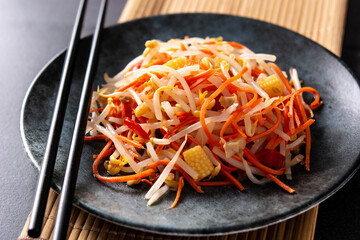 Wall Mural - Healthy Chinese cabbage salad in plate on black background	