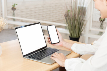 Wall Mural - computer screen,cell phone blank mockup.hand woman work using laptop texting mobile.white background for advertising,contact business search information on desk in cafe.marketing,design