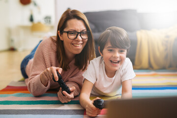 Wall Mural - mother and son playing video games at home