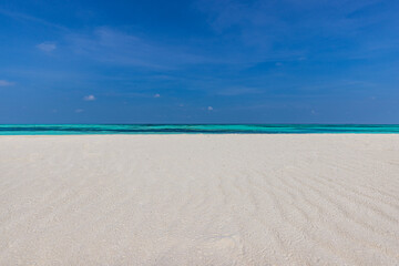 Closeup sandy beach waves and blue summer sky. Panoramic beach landscape. Empty tropical beach and seascape. Bright blue sky, soft sand, calmness, tranquil relaxing sunlight, summer mood