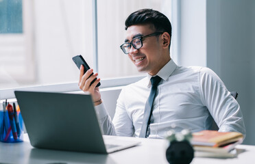 Sticker - Young Asian businessman working at office