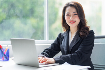 Wall Mural - Image of young Asian businesswoman working at office