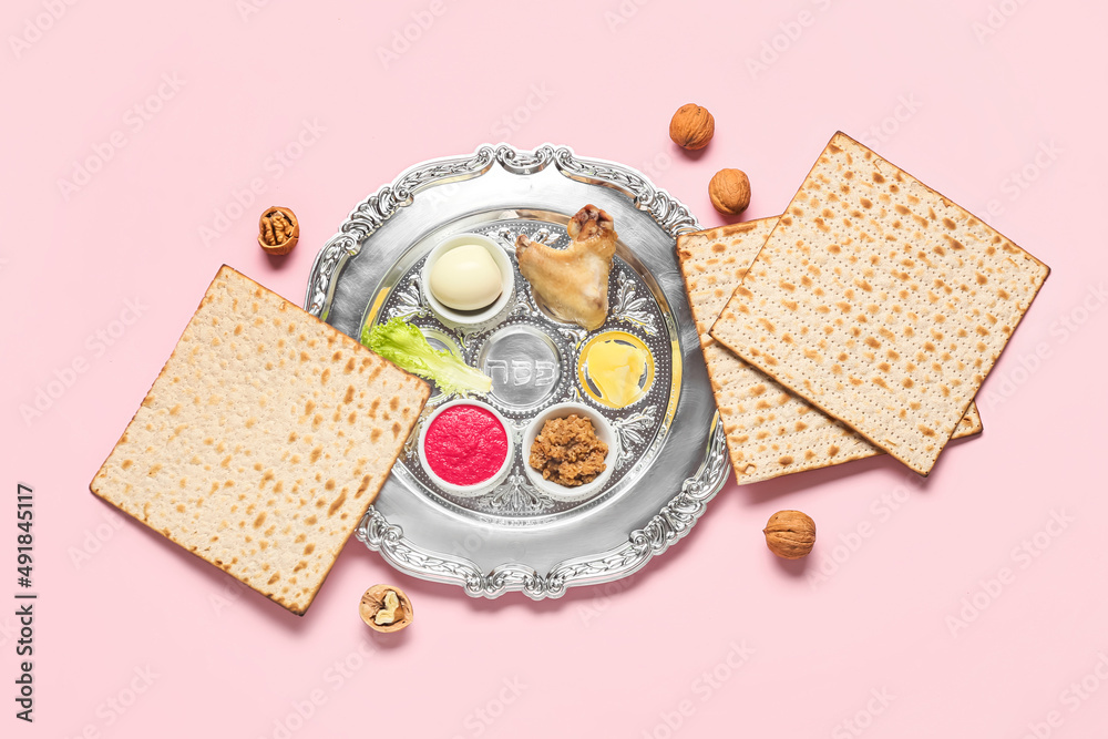 Passover Seder plate with traditional food on color background, top view