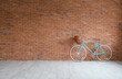 © Pixel-Shot - Modern bicycle near brick wall in empty room