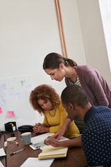 Poster - Id like to give this more attention. Shot of a group of colleagues having a meeting in a modern office.
