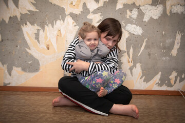 Portrait of a frightened   girls near  old gray wall . The concept of child abuse