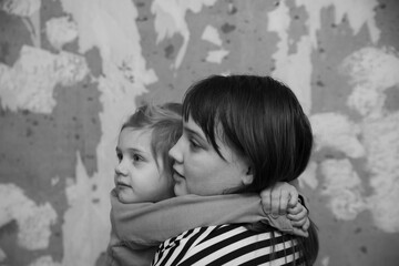 Frightened children   standing against   wall huddled together