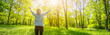 © candy1812 - Woman standing in the spring natural park with wide openning hands.