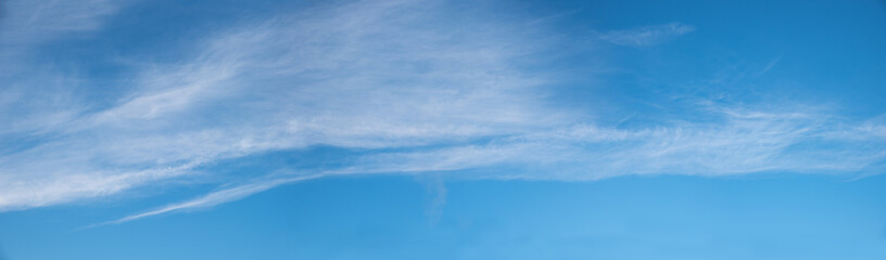 Wall Mural - floating cirrostratus clouds, windy weather, blue sky panorama