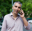 © JackF - Portrait of man who is standing near his car and talking by phone outdoors.