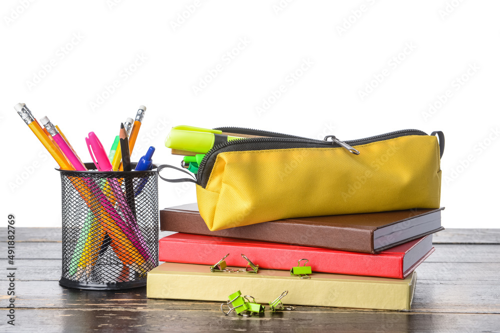 Set of stationery on wooden table against white background