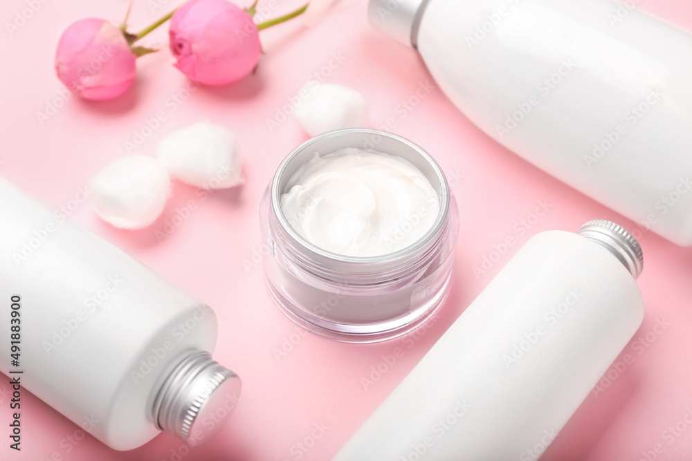 Different cosmetic products on pink background, closeup