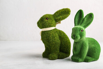 Cute green Easter bunnies on light background