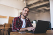 © BullRun - Millennial businessman working at desk in office