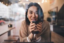 Young Millennial Asian Girl Working In Cafe
