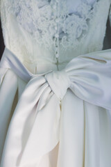 Wall Mural - Close up of an elegant wedding dress with big bow