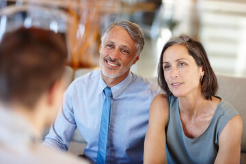 Wall Mural - Theyre a great team - in life AND business. A cropped shot of a mid adult couple having a meeting with a young businessman.