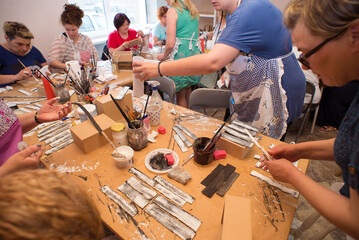 Women in art workshop making decoupage boxes