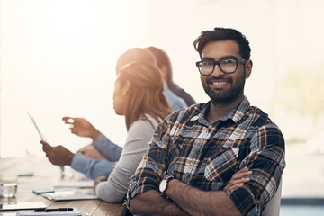 Poster - Our meetings are all about progress. Portrait of a confident young businessman sitting in on a meeting with colleagues in a modern office.