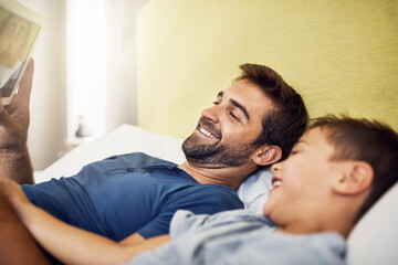 Wall Mural - Nothing connects quite like technology does. Shot of a young man using a digital tablet with his son at home.