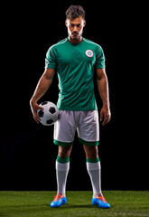 Joga Bonito. Full length studio shot of a handsome young soccer player isolated on black.