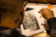 Portrait of a master calligrapher. A tattoo artist makes a sketch while sitting at a table in the Studio. Selective focus