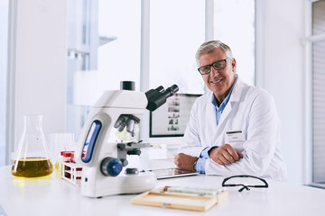 Poster - Science aids our curiosity of how the world works. Portrait of a mature scientist working in a lab.