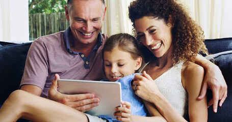 Sticker - Theyre one happy appy family. Shot of a cute little girl using a digital tablet with her mother and father on the sofa at home.