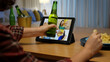© ChayTee - Young happy attractive asia female enjoy relax night party event online celebration festive with friends at home sofa pr table clinking beer with glass and bottle drinking via online videocall.