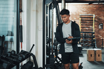 Aufkleber - I think were going to need one more of these.... Cropped shot of a handsome young male fitness instructor inspecting exercise equipment while working in a gym.
