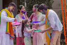 Indian Family Celebrating Holi Together With Colour