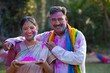 © IndiaPix - Portrait of middle aged couple with colourful faces on Holi