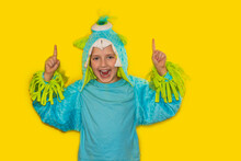 Handsome Schoolboy In Monster Costume. Yellow Background.Kid Point Finger Up . Child Cute Face . Boy Carnival Look Recommend Check This Out. This Direction. Subscribe Or Check. 